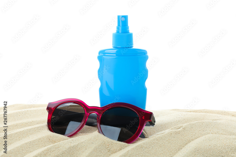 Sunscreen with sunglasses on clear sea sand isolated on white background. Summer vacation Sunscreen with sunglasses on clear sea sand isolated on white background. Summer vacation