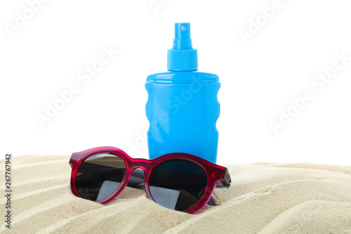 Sunscreen with sunglasses on clear sea sand isolated on white background. Summer vacation