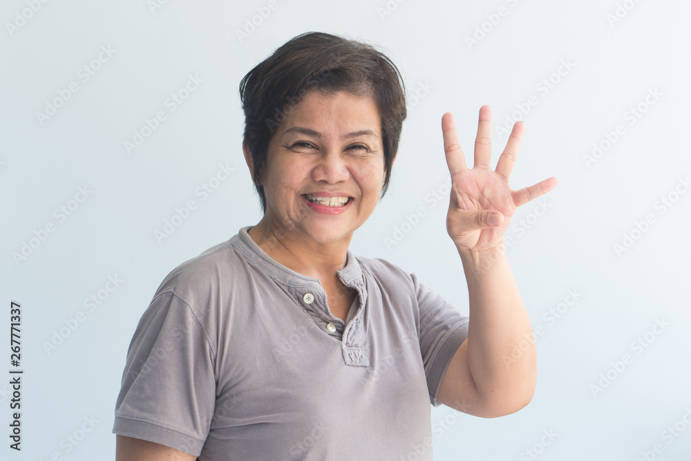 happy smiling Asian senior woman pointing up 4 fingers happy smiling Asian senior woman pointing up 4 fingers