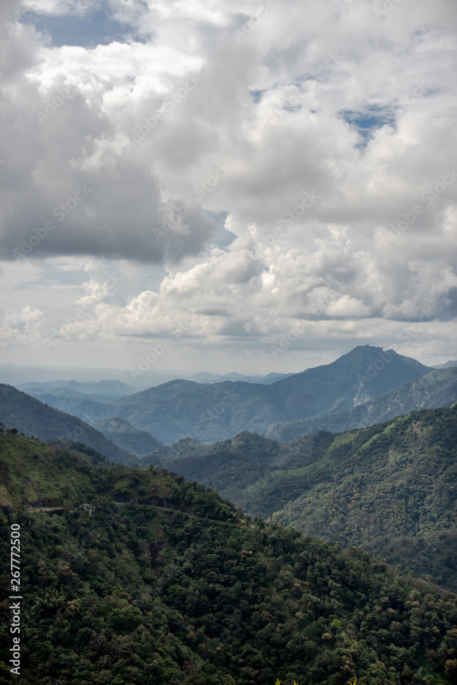 Hill range with white cloud and green forests Hill range with white cloud and green forests