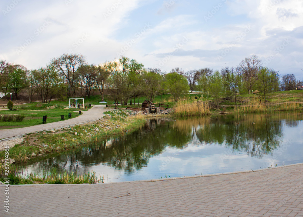 Beautiful park in spring and unidentified people in the park. Beautiful park in spring and unidentified people in the park.