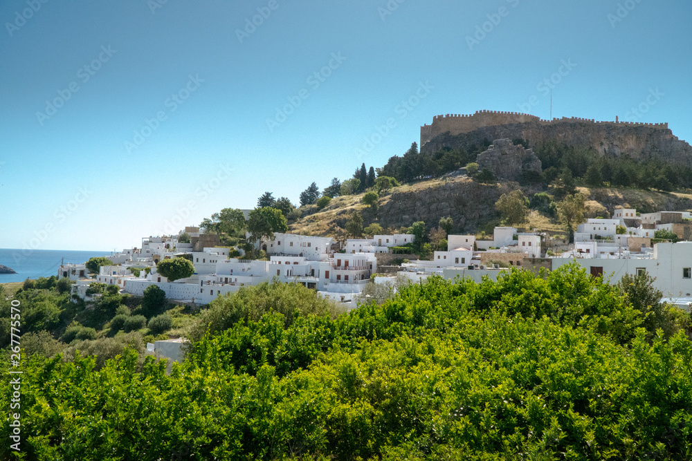 Lindos ,Rhodes/Greece May 2 2019 : the most historic village of the island and the view of the acropolis and the white houses from the square