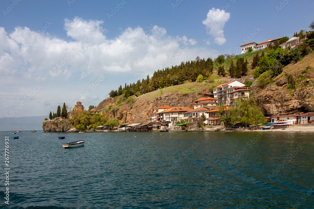 A view from Ohrid Lake to Ohrid's Fishermen's Quarter with St. Kaneo's Church on a cliff. Northern Macedonia.