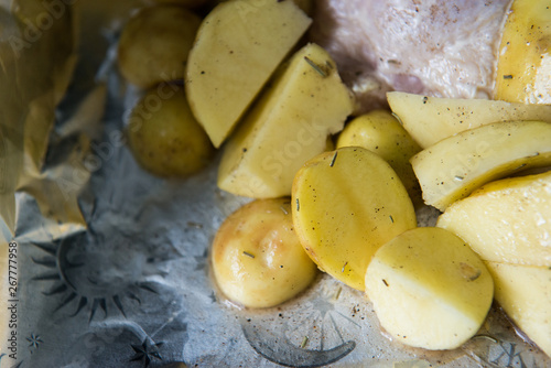 Raw chicken leg with potatoes ready to be cooked. Raw chicken with raw potatoes in the form for baking  ready to be cooked.