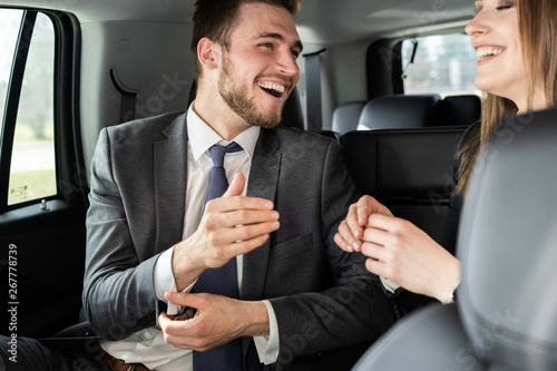 Conversation of two business people in driving car © opolja