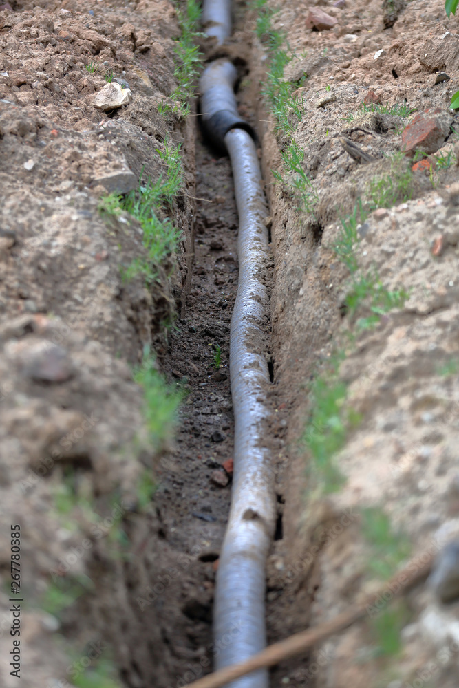 Steel pipes of the water pipeline in the excavated ground ditch Steel pipes of the water pipeline in the excavated ground ditch