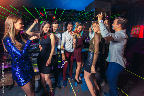 Group of friends partying in a nightclub