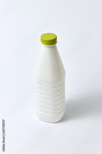 Mock-up dairy bottle from plastic on a light background.