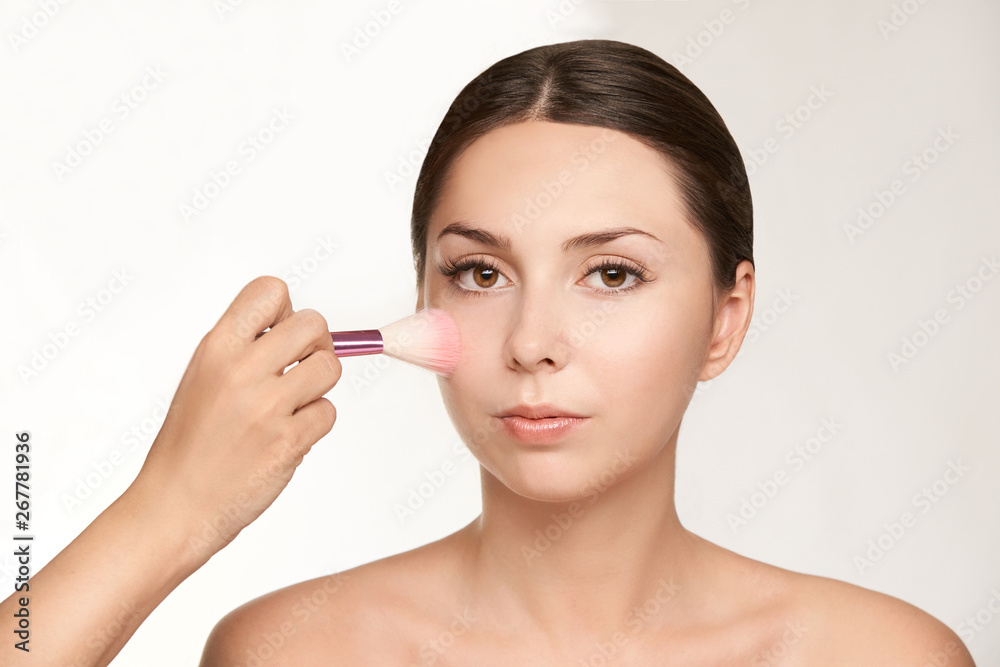 Woman make makeup. Face cosmetic. Skin care. Facial hightlighter. Mascara