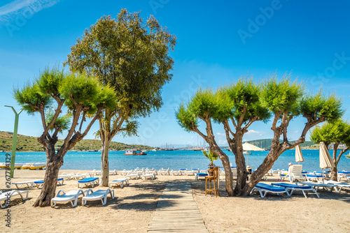 Beautiful exotic beach with deck chairs in Bodrum, Turkey photo