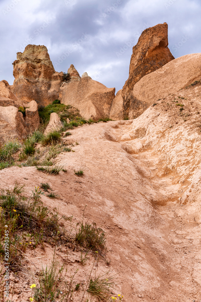 Mountains in the valley in Cappadocia. Beautiful landscape. Vertical. Mountains in the valley in Cappadocia. Beautiful landscape. Vertical.