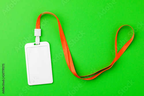 Blank security tag with a red stripe neck on a green background. Place for text, layout