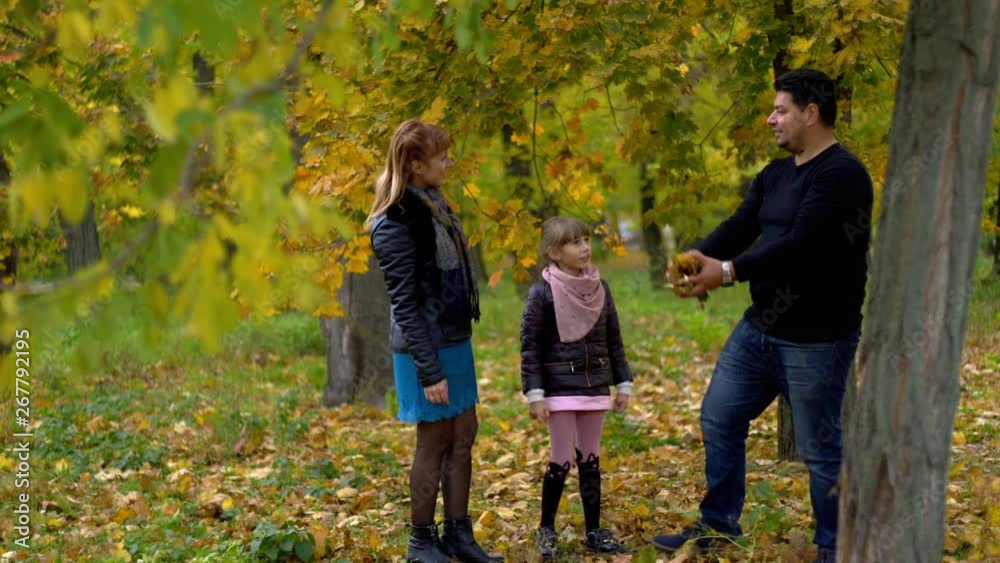 happy family dad mom and daughter in autumn park happy family dad mom and daughter in autumn park