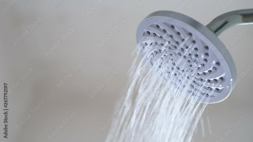 Slow Motion footage water flowing from shower head. Concept of