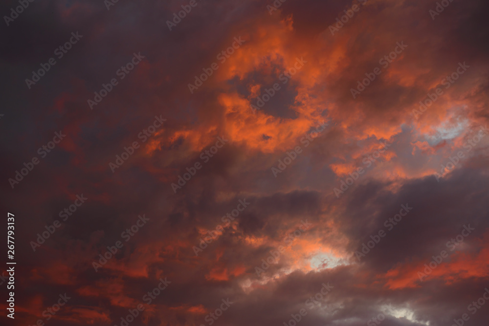 Dramatic sky with dark, red clouds at sunset
