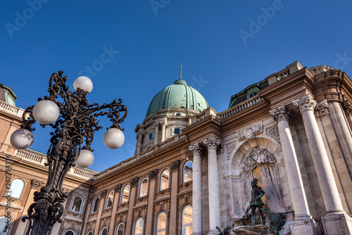 Canvas Print Hungary, Budapest, Buda, Hunyadi Udvar: Famous facade of Royal Palace at Castle Hill district above the city center of the Hungarian capital with vintage lantern and blue sky - concept architecture