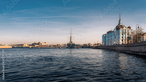 Rear view of the Cruiser Ship Aurora on the Neva River in Saint Petersburg, Russia with the Nakhimov Naval School's facade at dawn