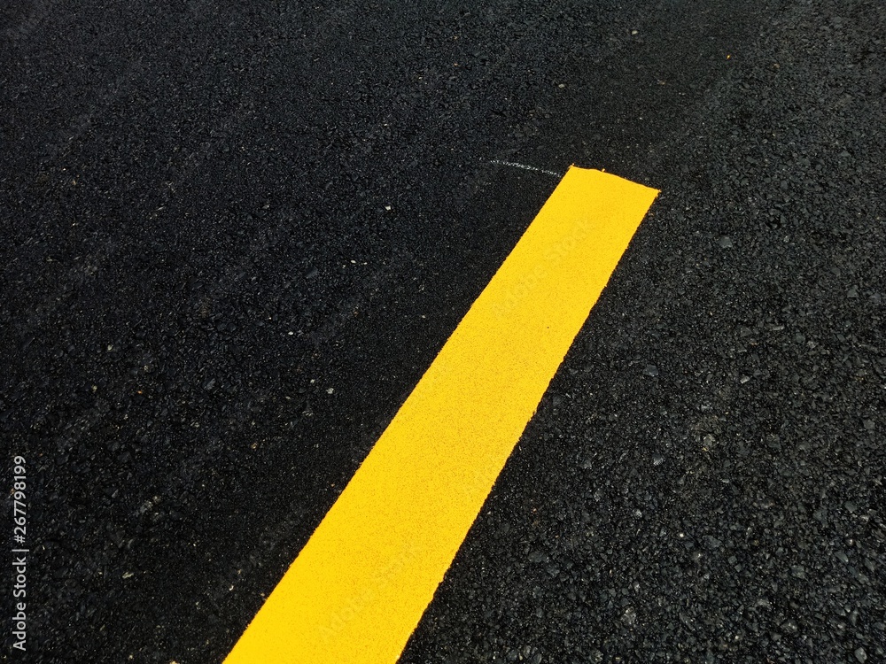Road traffic paint Yellow on the asphalt surface