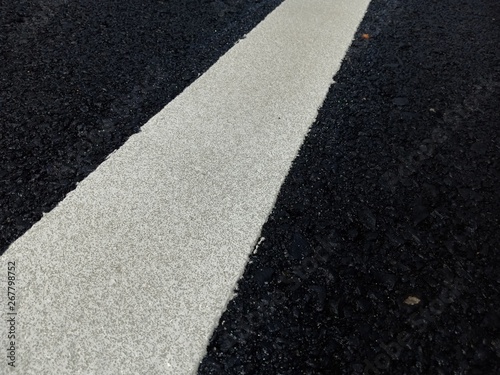 Road traffic paint White on the asphalt surface © suwichan