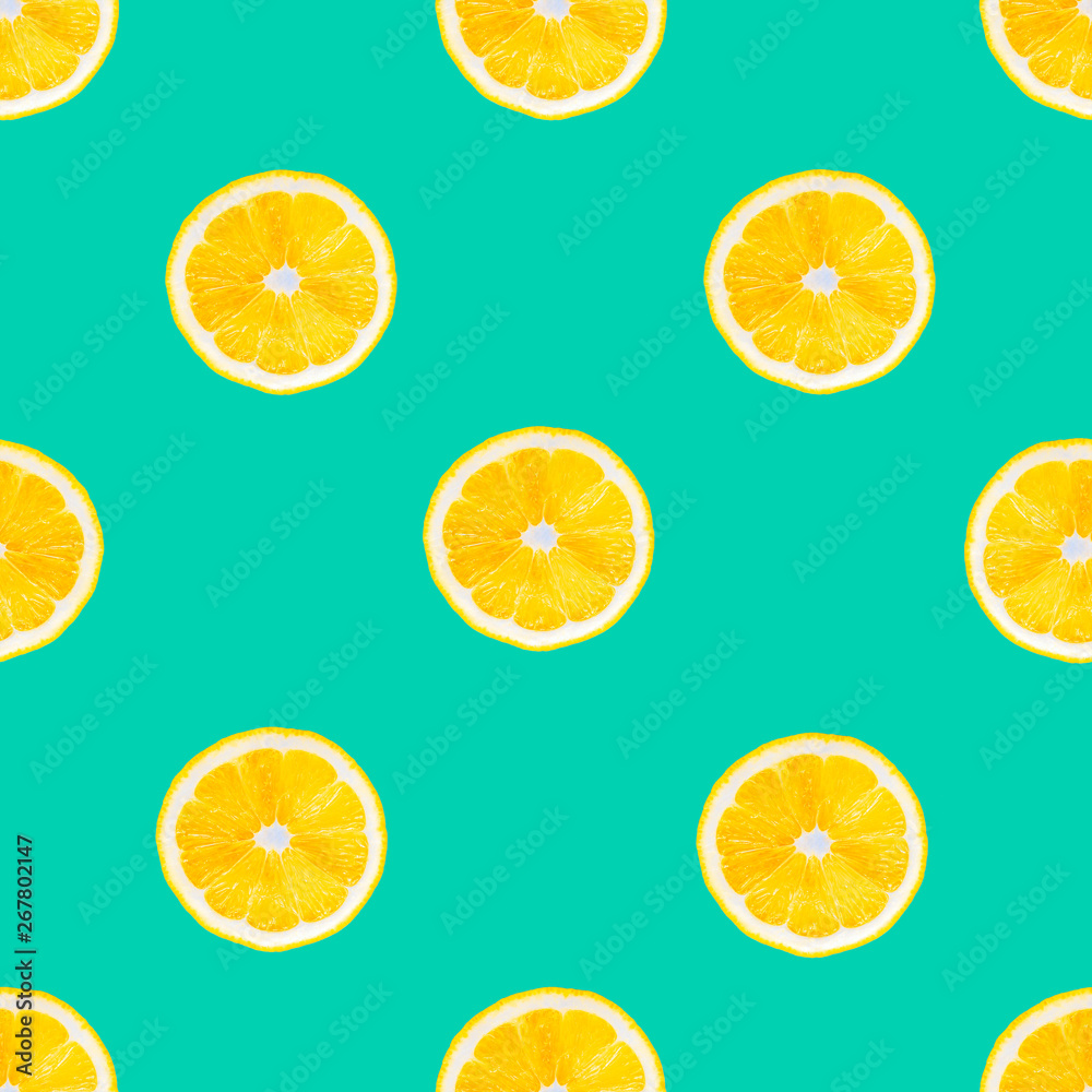 Lemons slice on green background. Summer fruits seamless pattern, geometric ornament. Lemon texture design for textiles, wallpaper, fabric.
