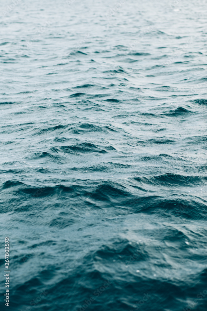 Naklejka premium ripples on blue sea water , natural sea background