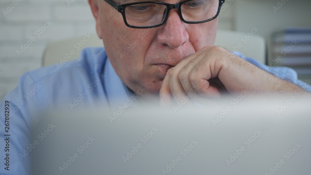 Image with Businessman Reading Preoccupied Financial Information from a Laptop Image with Businessman Reading Preoccupied Financial Information from a Laptop