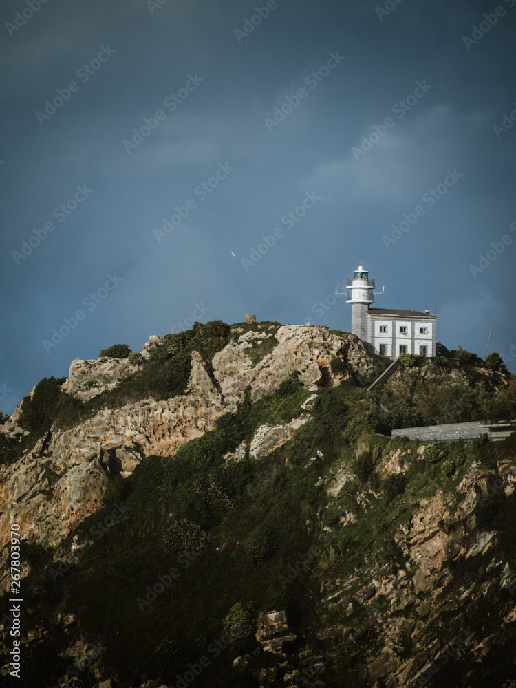 Getaria's lighthouse with storm clouds in the background