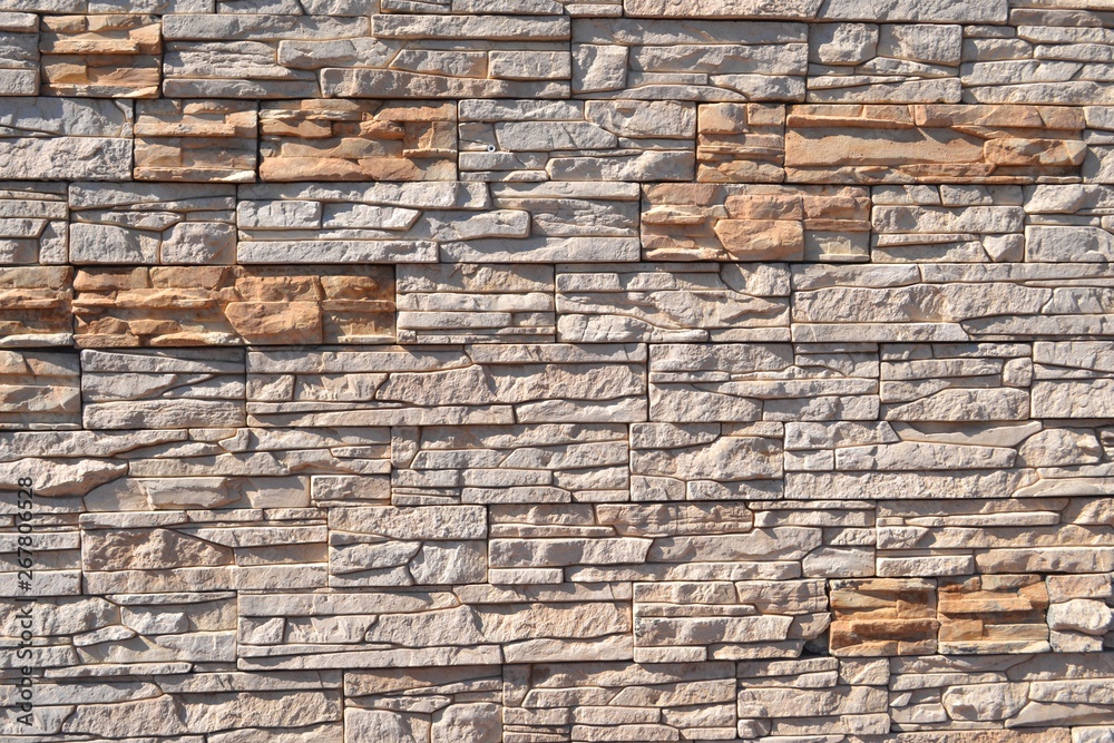 Vintage artificial stone masonry wall,sunlit