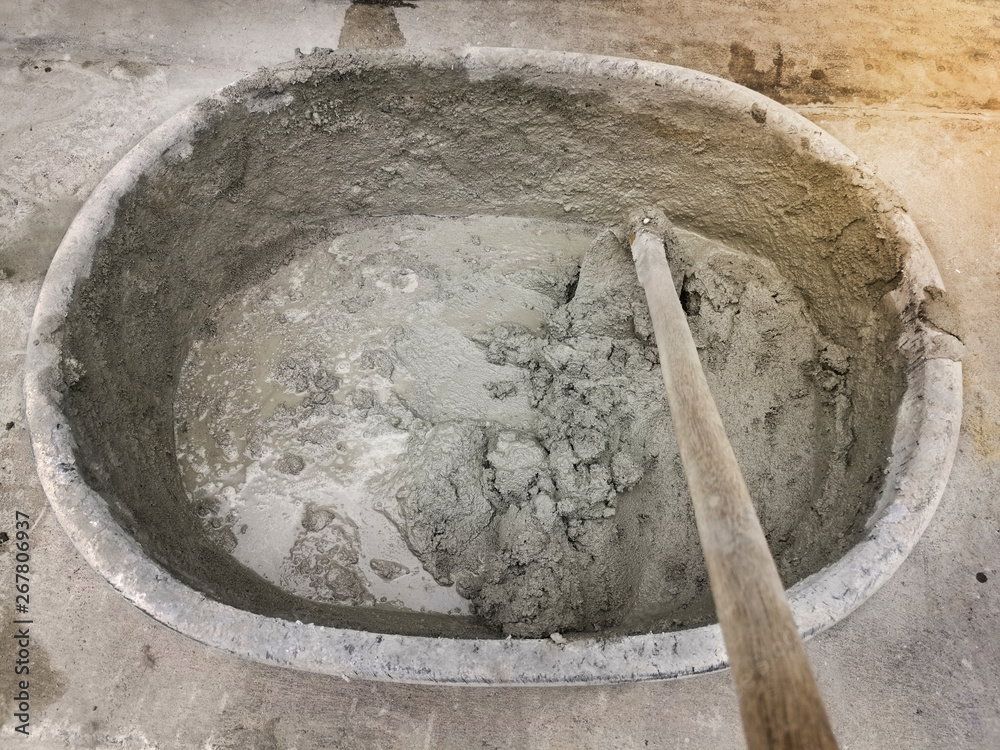Mixing cement, sand, stone in the basin for mixing