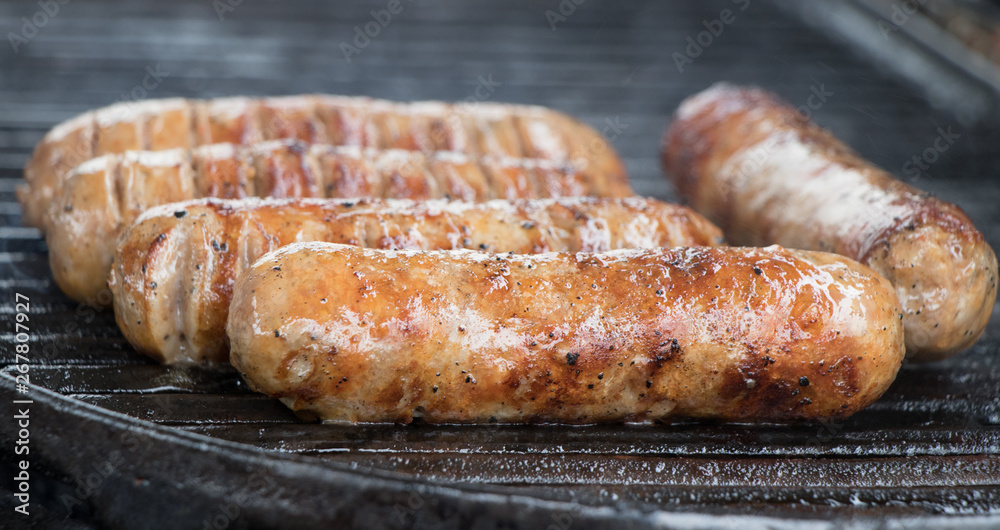 grilling sausages on the barbeque