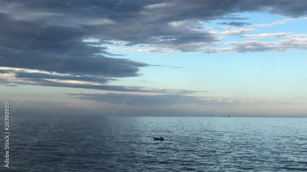 Man in boat rowing in the sea Man in boat rowing in the sea