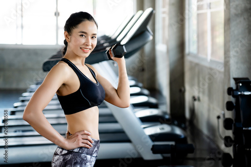 Concept of doing business, opening gym Asian women are exercising using dumbbells to reduce arms. Increase strength of muscles. Regular exercise will result in a balanced shape and good mental health.