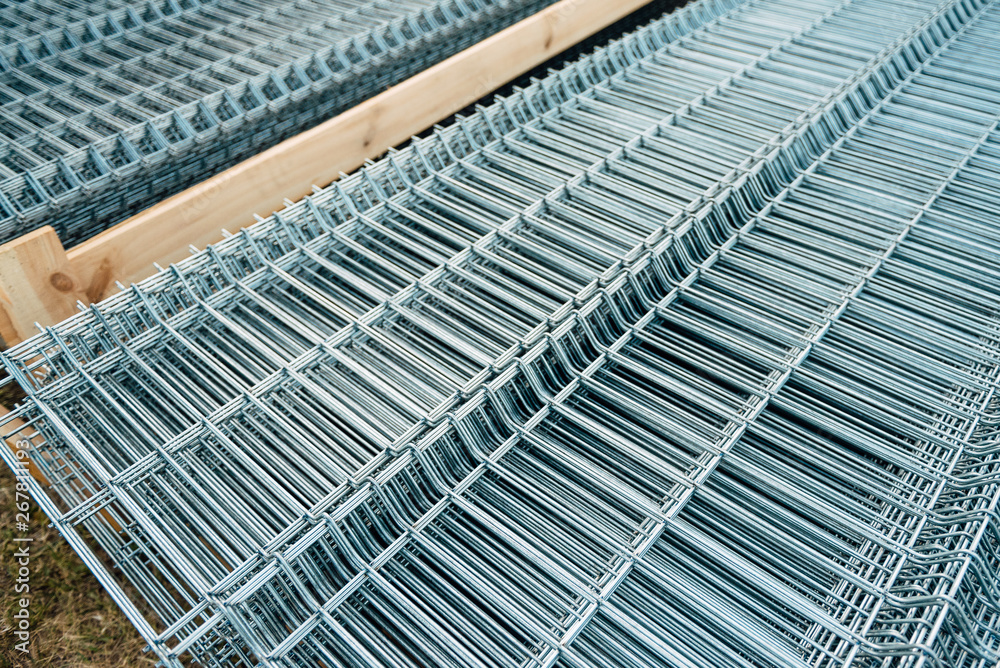 Shiny polished metal construction grid, folded in flat pile, poured into cold metallic shades, fittings, wire. Shiny polished metal construction grid, folded in flat pile, poured into cold metallic shades, fittings, wire.