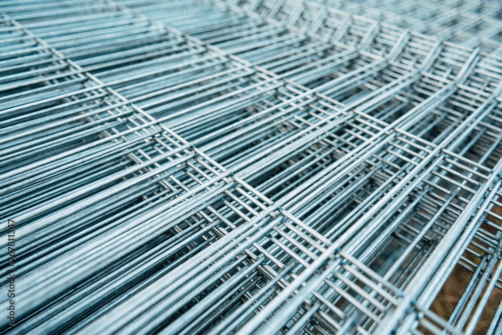 Shiny polished metal construction grid, folded in flat pile, poured into cold metallic shades, fittings, wire. Shiny polished metal construction grid, folded in flat pile, poured into cold metallic shades, fittings, wire.
