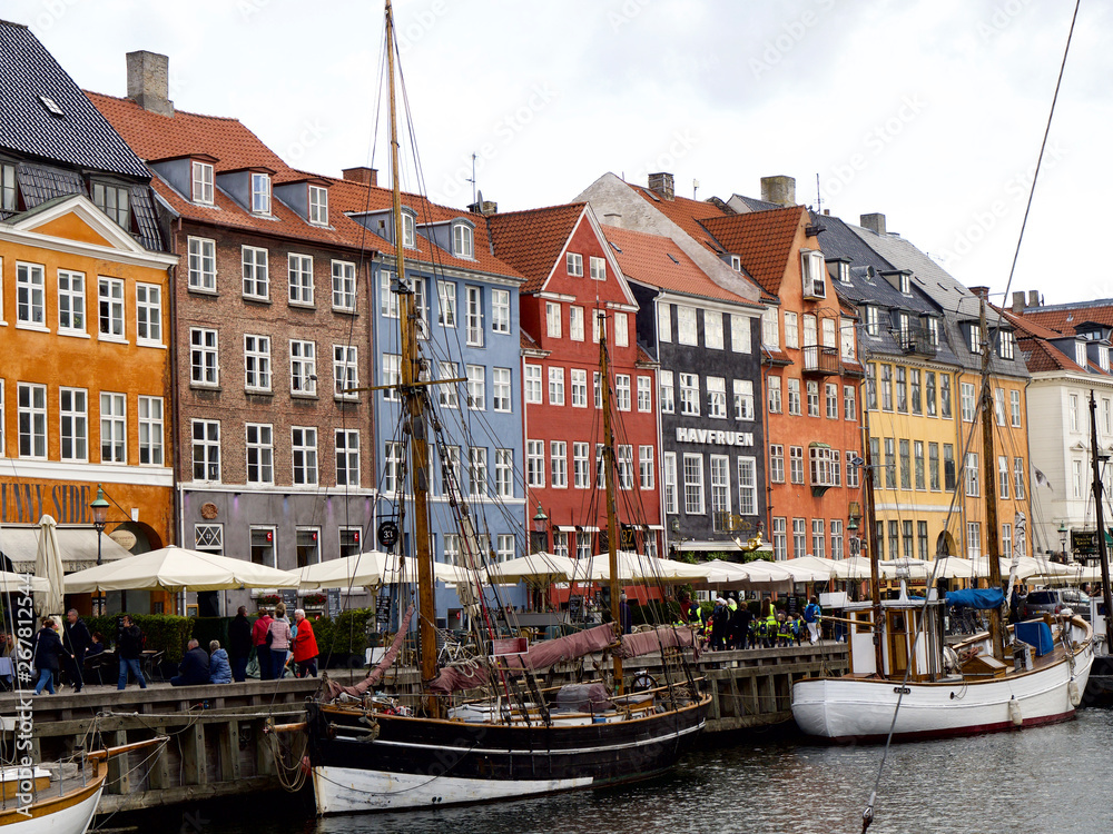 Nyhavn with colorful facades of old houses and old ships in the Old Town of Copenhagen