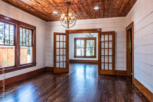 1950s interior cottage with original shiplap ceilings, floors, french doors open to living room.  Updated lighting. 