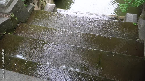 Waterfall rapids in public park, fast streaming water.