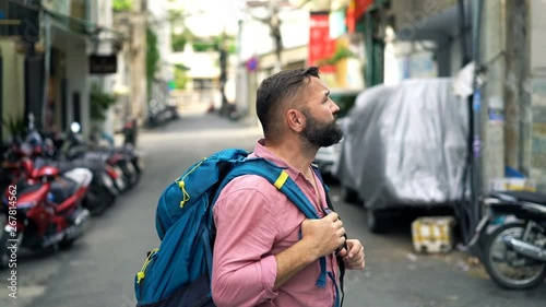 Young man, lost traveler, backpacker in the city