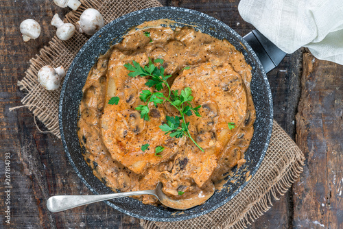 Tableau sur toile Pork chops in creamy cajun sauce with button mushrooms and parsley in a skillet