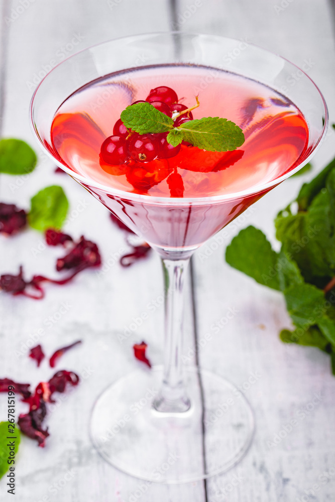 Jelly with red currant in martini glass on wooden background. Close up Jelly with red currant in martini glass on wooden background. Close up