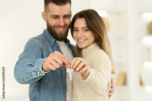 New Home Owners. Young Couple Holding House Key © Prostock-studio