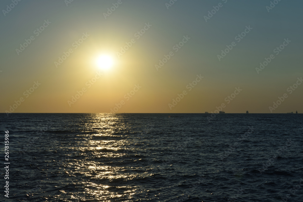 Beautiful orange sunset in the black sea with sun reflection in the city of Gelendzhik, Russia Beautiful orange sunset in the black sea with sun reflection in the city of Gelendzhik, Russia