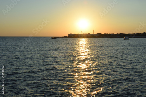 Beautiful orange sunset in the black sea with sun reflection in the city of Gelendzhik, Russia