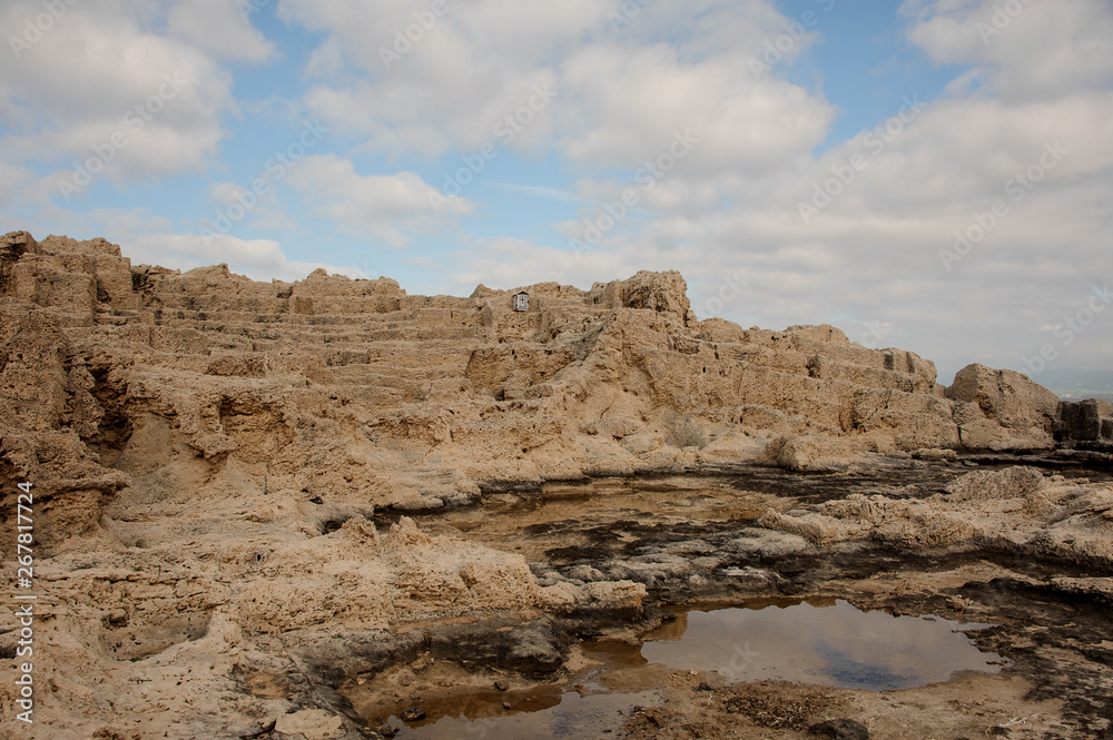 Shot of stone coast with small booth with cross