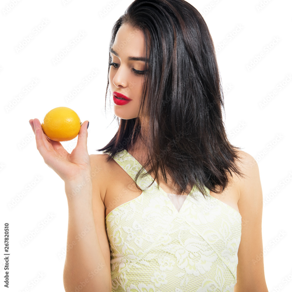 Excited beautiful girl holding lemon and posing in studio over white background. Excited beautiful girl holding lemon and posing in studio over white background.