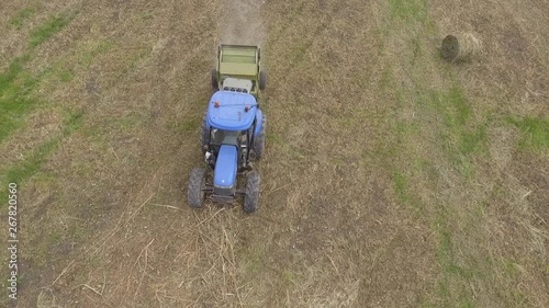 1Man at work on the tractor with hay baler photo