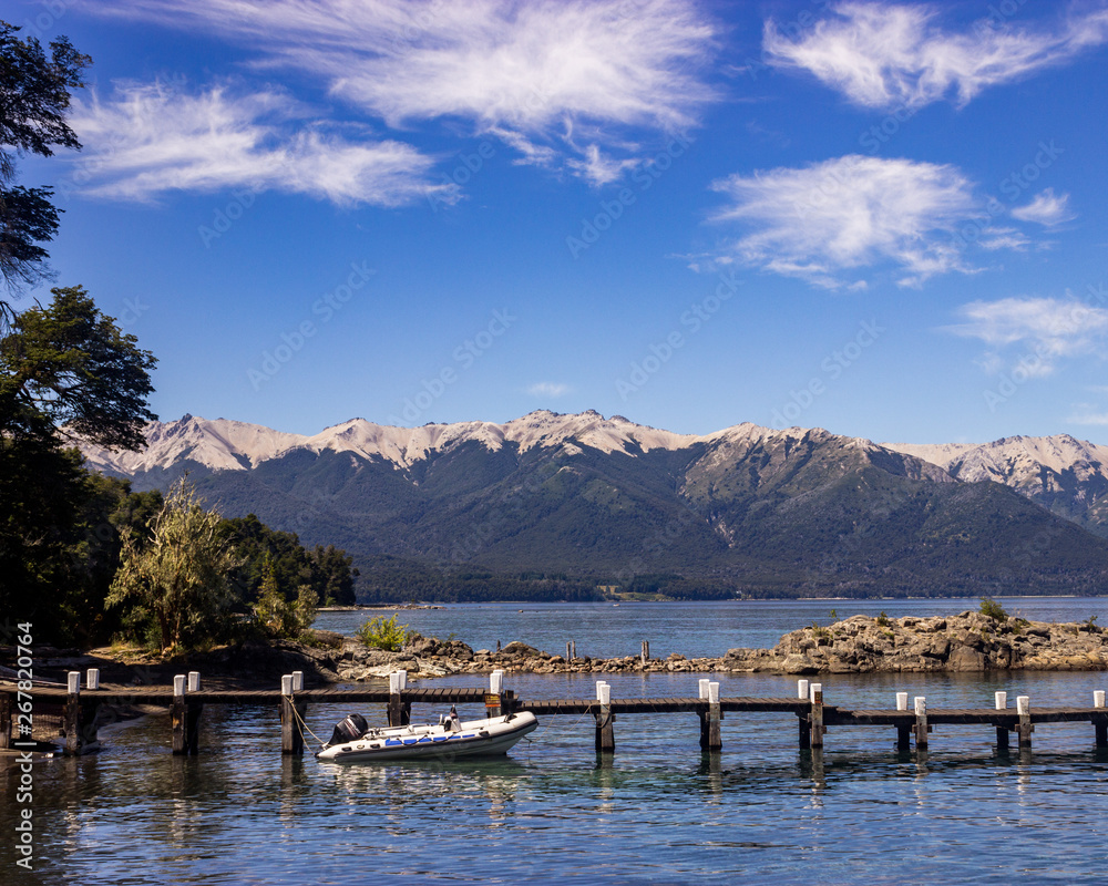 Landscape of a pier and boat with mountains in Bariloche
