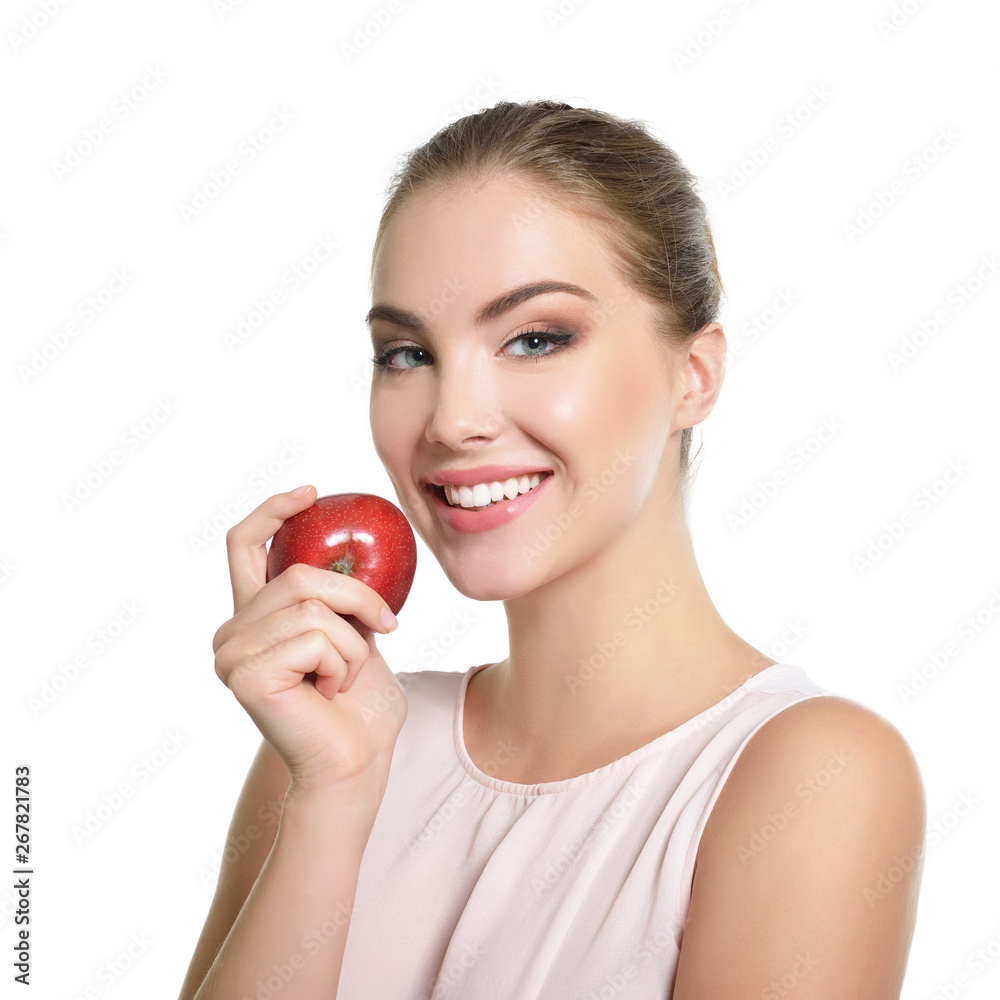 Beauty female portrait. Young attractive woman posing at studio with apple over white background. Beautiful girl with perfect smile. Model with perfect make-up Beauty female portrait. Young attractive woman posing at studio with apple over white background. Beautiful girl with perfect smile. Model with perfect make-up