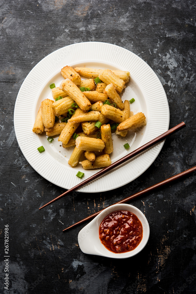 Baby Corn Manchurian dry - popular Indo-chinese starter recipe. selective focus Baby Corn Manchurian dry - popular Indo-chinese starter recipe. selective focus