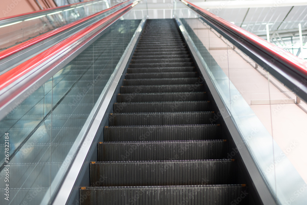 Escalator in shopping mall. Moving up and down staircase. electric escalator. Escalator in shopping mall. Moving up and down staircase. electric escalator.